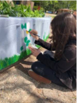 students painting flowers on the Shawmut Hills sycamore circle mural